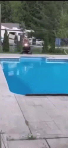 Man On A Snowmobile Crossing Swimming Pool GIF
