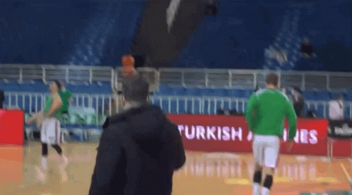 Man on Basketball Court in Front of Turkish Airlines Banner