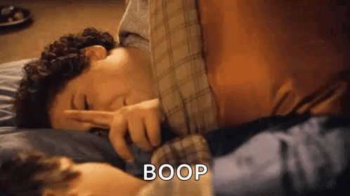 Man on Bed Making Peace Sign With Another Man