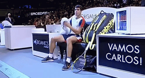 Man On Bench Beside Babolat Bag GIF