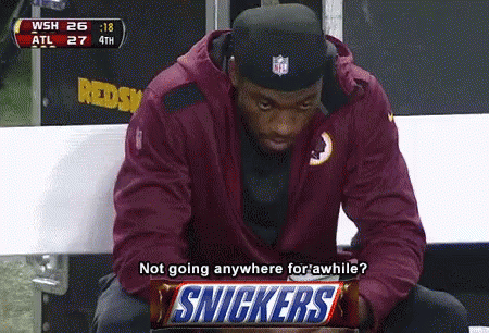 Man on Bench With Snickers Bar