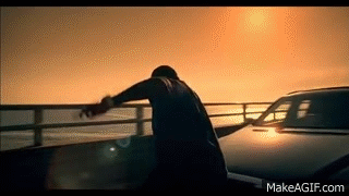 Man On Bridge Overlooking Ocean With Car GIF
