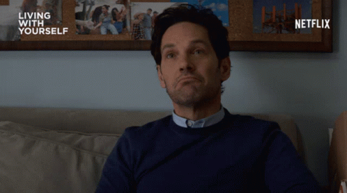 Man on Couch in Front of Netflix Ad