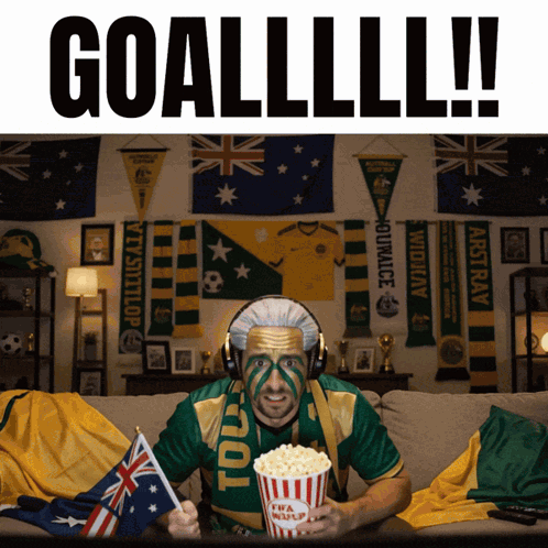 Man on Couch in Green Gold Shirt With Popcorn Saying Toul
