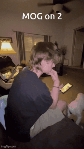 Man on Couch Looking at Cell Phone Mog on 2