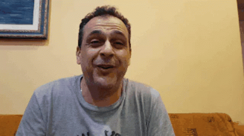 Man On Couch Wearing I Love You Grey Shirt GIF