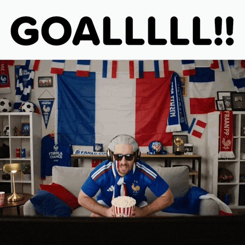 Man on Couch With Popcorn and Goal