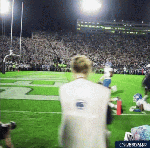 Man on Football Field Wearing Vest Saying Unrivaled