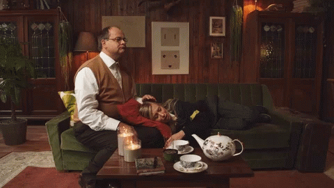 Man on Green Couch Woman on Lap