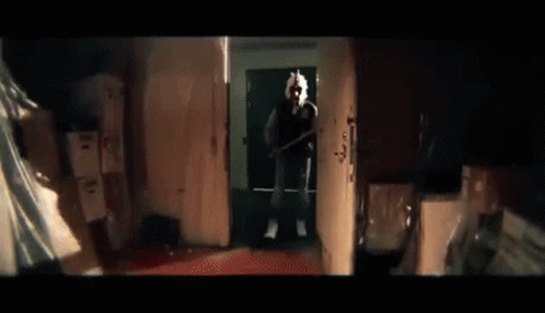 Man On Phone Holding Baseball Bat In Dark Room GIF