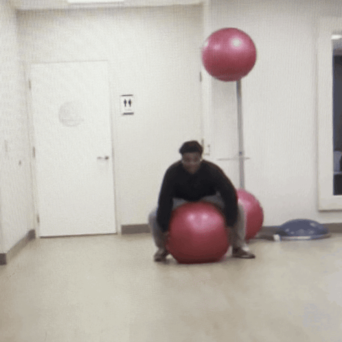 Man On Pink Exercise Ball By T & T Sign GIF