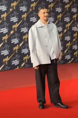 Man on Red Carpet in Front of Music Awards Wall