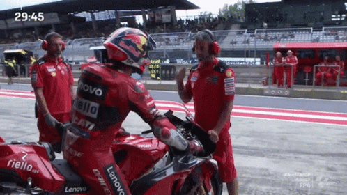 Man on Red Motorcycle With Fiello on Back