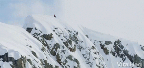 Man On Snowmobile Jumping Off A Cliff GIF