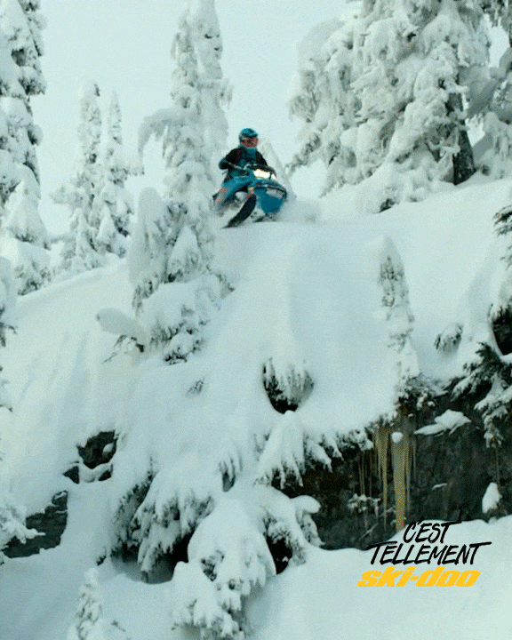 Man On Snowmobile Jumping Off A Snowy House GIF