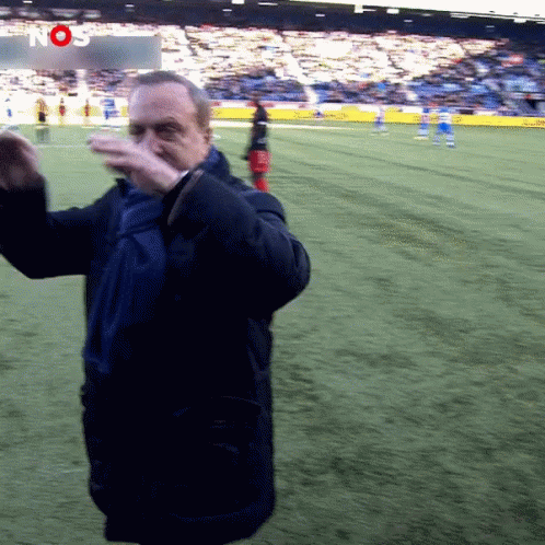Man on Soccer Field Before Nos Sign