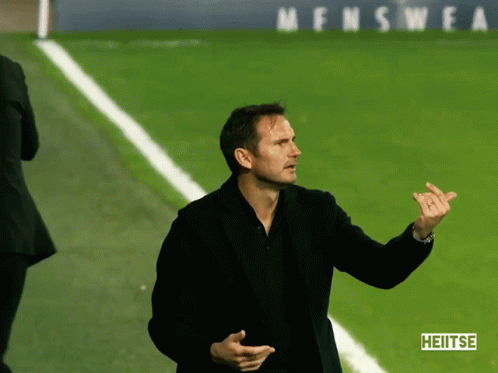 Man On Soccer Field Holding Hublot Sign GIF
