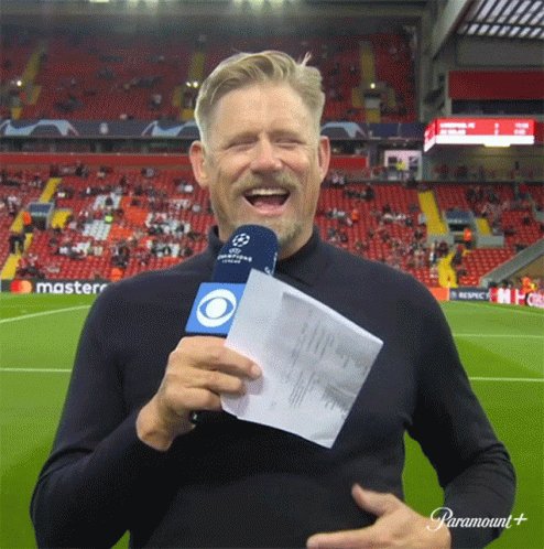 Man on Soccer Field Holding Microphone