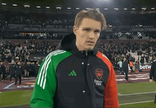 Man On Soccer Field Wearing Arsenal Jacket GIF