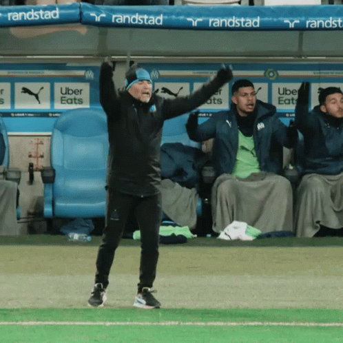 Man on Soccer Field With Arms in Air