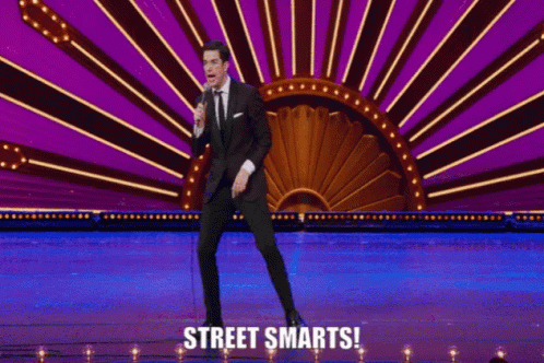 Man on Stage Holding Microphone with Street Smarts