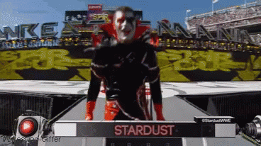 Man On Stage With Stardust Sign GIF
