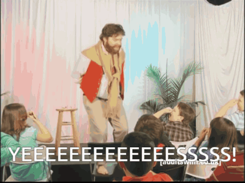 Man on Stage Yelling Yeeeeeeeeeeesss to Children