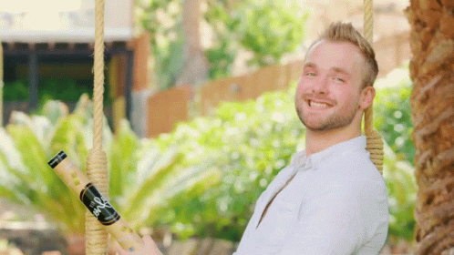 Man on Swing Holding Bio Bottle