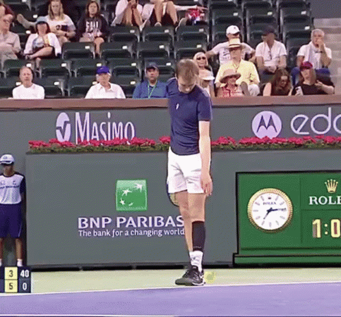 Man on Tennis Court in Front of BNP Paribas Ad