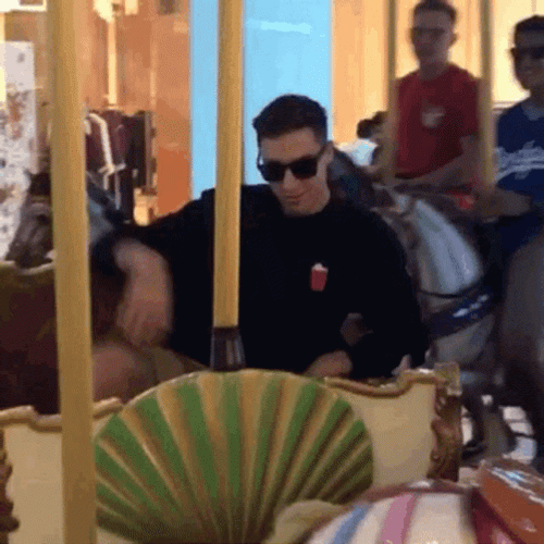 Man On The Carousel Blowing Kiss GIF