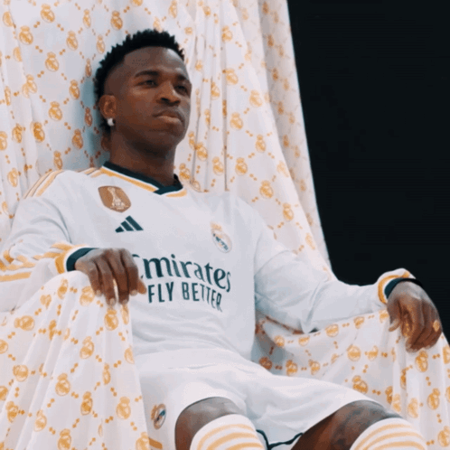 Man on Throne in Emirates Fly Better Jersey