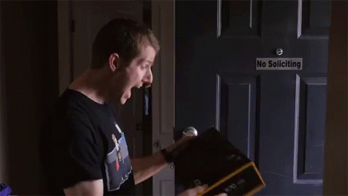 Man Opening Box In Front Of No Soliciting Sign GIF