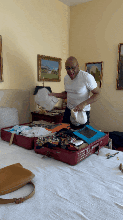 Man Packing Bags While Dancing GIF