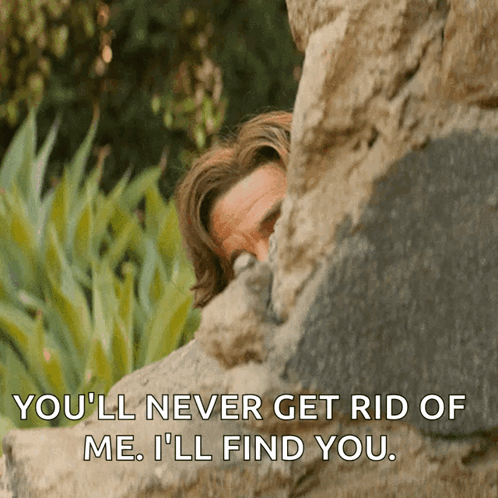 Man Peeking Behind Rock Youll Never Get Rid of Me