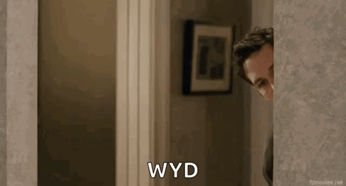 Man Peeking Out Doorway Saying WYD