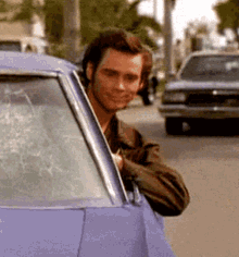 Man Peeking Out of Purple Car Window