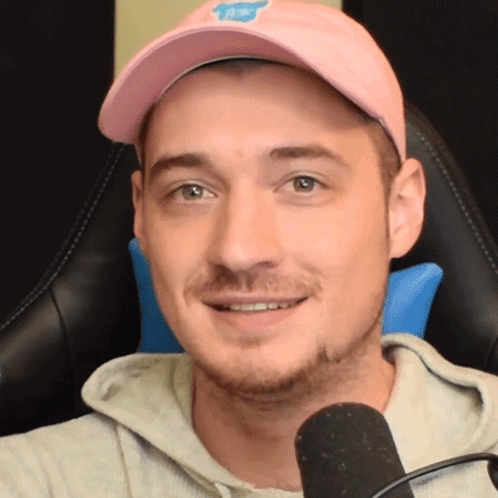 Man Pink Hat Grey Hoodie Smiling Microphone