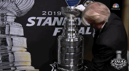 Man Placing Stanley Cup On A Table GIF