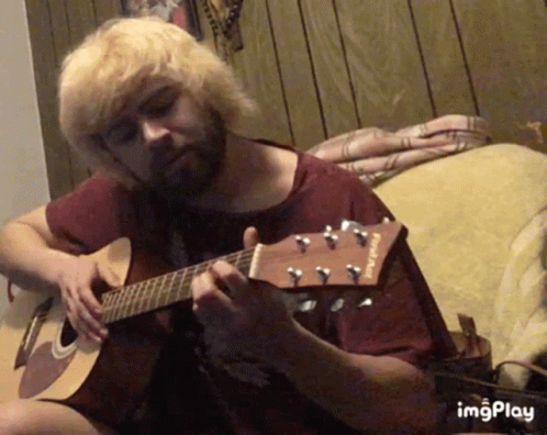 Man Playing Acoustic Guitar with Fender Shirt