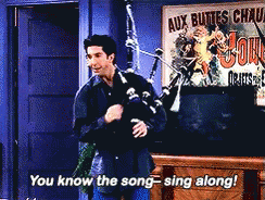 Man Playing Bagpipe With aux buttes chaud Sign