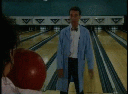 Man Playing Bowling With Bowling Ball in Mouth