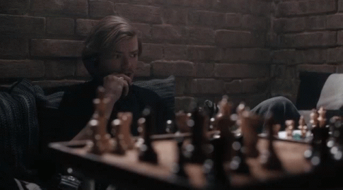 Man Playing Chess On Couch GIF