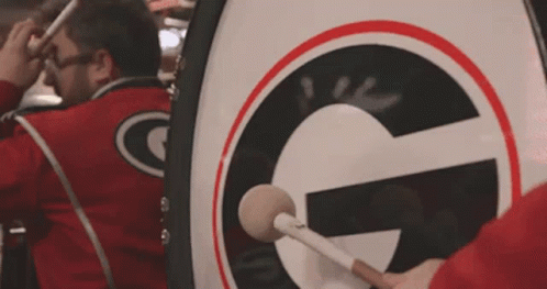 Man Playing Drum With Letter G GIF