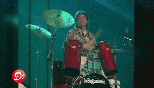 Man Playing Drums in Front of La Baguetterie