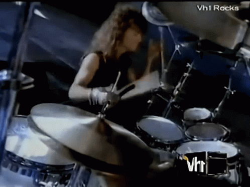 Man Playing Drums In Front Of VH1 Rocks Logo GIF
