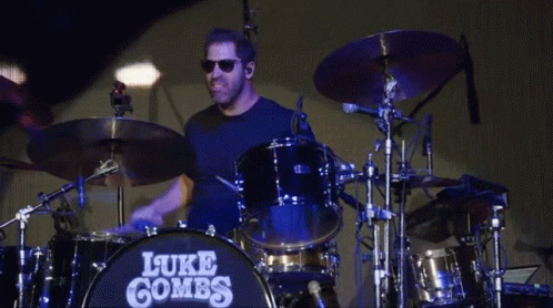 Man Playing Drums With Name Luke Combs GIF