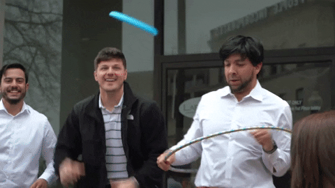 Man Playing Frisbee In A Crowd GIF