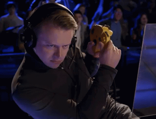 Man Playing Game With Headphones and Yellow Controller