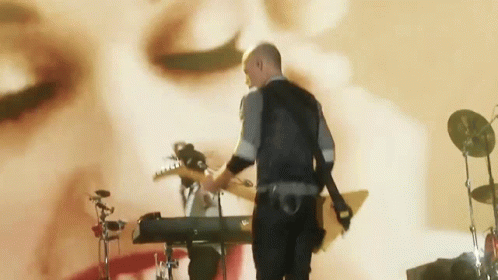 Man Playing Guitar and Keyboard