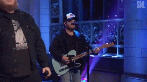 Man Playing Guitar And Singing Into Microphone GIF